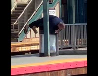 man face down trash can plays flute