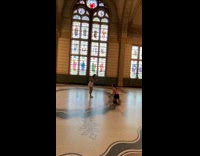 Two women take turns to pose inside Rijksmuseum
