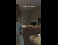 GIrl in white shirt howls and her dog howls with her 