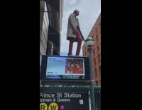 Guy dances on top of sign for subway