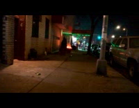 Car tire around planter burn street night