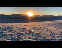 Time lapse of sun setting behind mountains