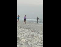 Woman in black top dances with the waves