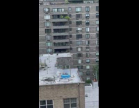 Man sleep on kiddie pool rooftop building