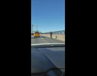 Man on a scooter takes over right lane on bridge