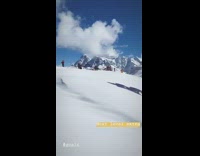 Red gown on snowy mountain top 