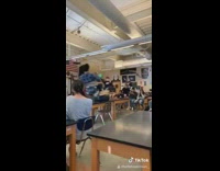 Two guys on spinning table in class seesaw