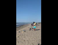Man in blue shorts adjust camera for a timer photoshoot