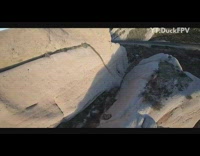 Drone flies over grey brown mountains freeway 