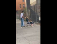 Face mask guy cuts hair girl sidewalk 