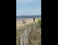 Black dress girl purple smoke bomb beach 