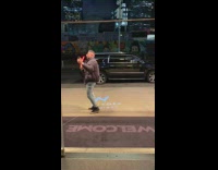 Guy takes selfie New York logo lights