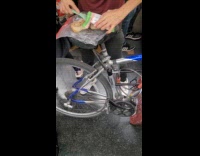 Person make tuna sandwich on bike inside train
