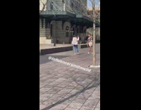 Pink shorts guy dances walkway white jacket