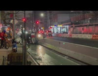 People help push car off the barrier