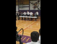 Guy throws water bottle cap gym floor