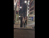 Two women tiktok dance Christmas bell street