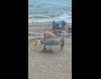 Collab IITW - Man in speedos hold printed cloth beach