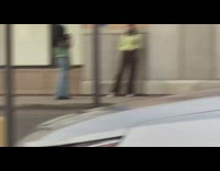 Green cardigan girl poses brown wall sidewalk 