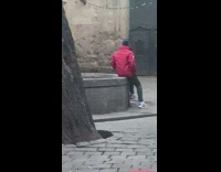 Woman poses in front of wall with holes