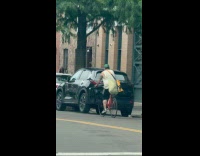 Cyclist carry fan propeller spins around street