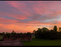 Takes video of sunset outside the street