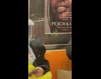 Baby boy stares at woman riding subway 