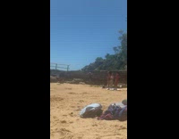 Guy backflip fail from stone ledge beach