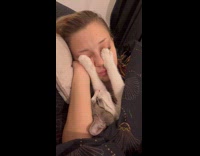 Cat holding girls eyes closed sleeping 