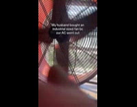 Woman using industrial size fan