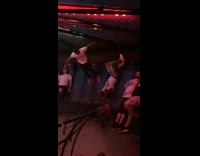 Guy standing up on carnival fair spinning gravity ride