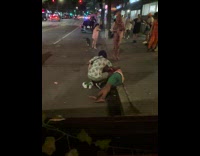 Guy with drunk friend passed out on street