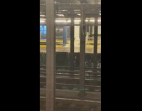 waters from stairs rush into subway train tracks