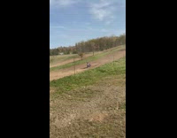 Son rides dirtbike on path 