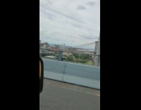 Guy honks at guys riding bicycles across bridge 