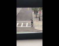 Guy not fully worn coat cross street