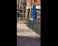 Guy walks with pants down by knees 