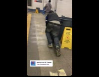 Guy lays on and rides rolling suitcase 