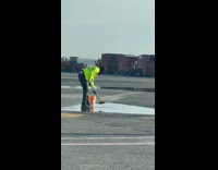 Man shovel water into the bucket airport