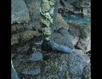man in camouflage wet suit pees himself