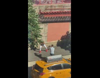 Hip hop dancer performs for video on sidewalk 