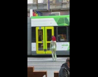 Green jumpsuit girl train passes by 