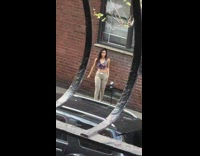 Woman violet floral crop top sidewalk photo shoot