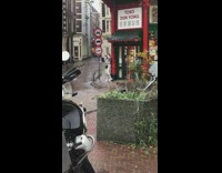 White jacket girl dances outside store rain