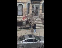 Lady cuts hair outside on sidewalk mirror 