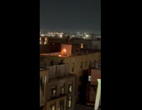 Man performs fire dance on the rooftop