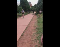 Woman green hula-hoop dance park walkway