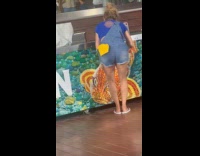 Woman yellow scarf behind tiktok at game