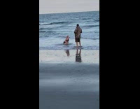 Woman black bikini kneel splash body beach