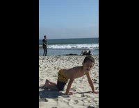 Guy in black clothes jumps for photo at beach 